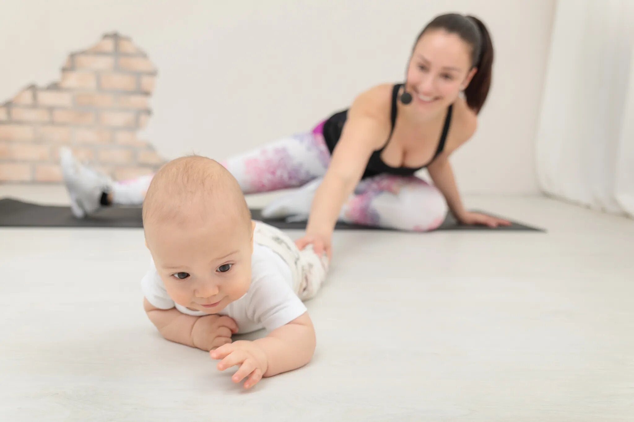 Äiti pitää vauvan jalasta kiinni 2baby äiti-vauvajumpassa